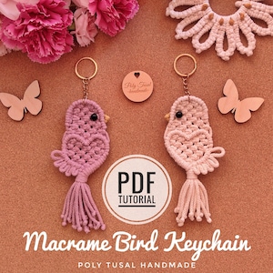 May include: Two macrame bird keychains in pink and peach, each with a gold keyring and a tassel tail. The birds have heart-shaped bodies and are displayed with wooden butterfly cutouts and flowers. The text "Macrame Bird Keychain" is visible.