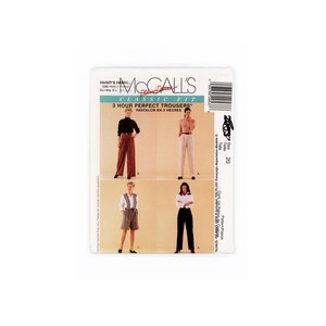 May include: A McCall's sewing pattern for classic fit trousers. The package shows images of various trouser styles, including wide-leg and tailored designs. The text on the package reads "3 Hour Perfect Trousers" and "PANTALON EN 3 HEURES".