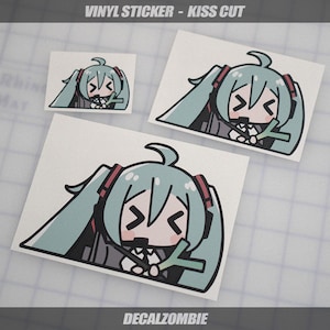 May include: Vinyl stickers with a kiss-cut design featuring a cartoon character with long, light teal pigtails, red accents, and a black outline. The stickers are on a white background, with the text "VINYL STICKER - KISS CUT" and "DECALZOMBIE".