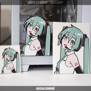 May include: Three vinyl stickers featuring a cartoon anime character with green hair, a white shirt, and a red and black headset. The character is wearing a black armband with the number "01" on it. The stickers are kiss cut, meaning they are cut around the design, leaving a white border around the character.