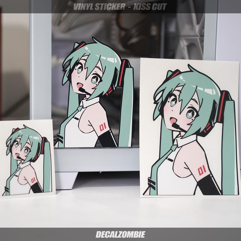 May include: Three vinyl stickers featuring a cartoon anime character with green hair, a white shirt, and a red and black headset. The character is wearing a black armband with the number "01" on it. The stickers are kiss cut, meaning they are cut around the design, leaving a white border around the character.