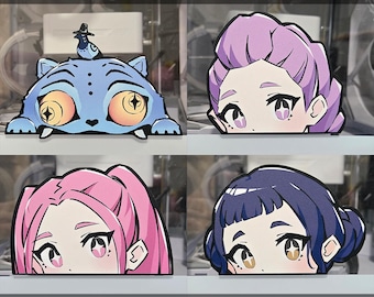 May include: Vinyl die-cut stickers featuring four unique designs. Includes a blue cartoon cat with a bird, and three anime-style character faces with pink, purple, and blue hair. The text "VINYL STICKER - DIE CUT" and "DECALZOMBIE" are visible.