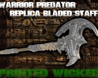 May include: A clear, bladed staff with intricate detailing, featuring a curved blade design. The staff has a long handle and is set against a textured, metallic background. Text on the image reads "WARRIOR PREDATOR REPLICA BLADED STAFF" and "PRINTED WICKED".