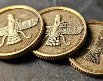 May include: Three gold-colored round coins with a detailed relief design. Each coin features a central figure with outstretched wings and intricate patterns. The coins have a textured surface and a ridged edge, with the text "Printed Wicked" visible.