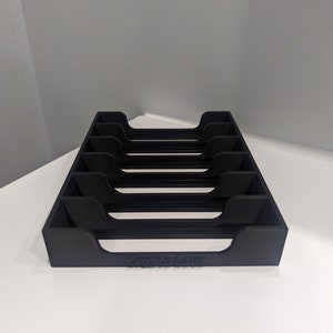 May include: Black plastic card holder with six slots and the text "Lupita Lane" printed on the bottom.
