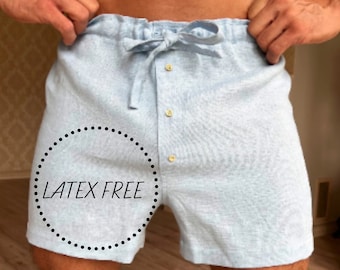 May include: Light blue pyjama shorts with a drawstring waist and button fastening. The shorts have a "LATEX FREE" label on the left leg.