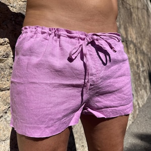 May include: Light purple linen shorts with a drawstring waist. The shorts are made of a lightweight fabric and have a relaxed fit. The shorts are a solid color and are suitable for warm weather.