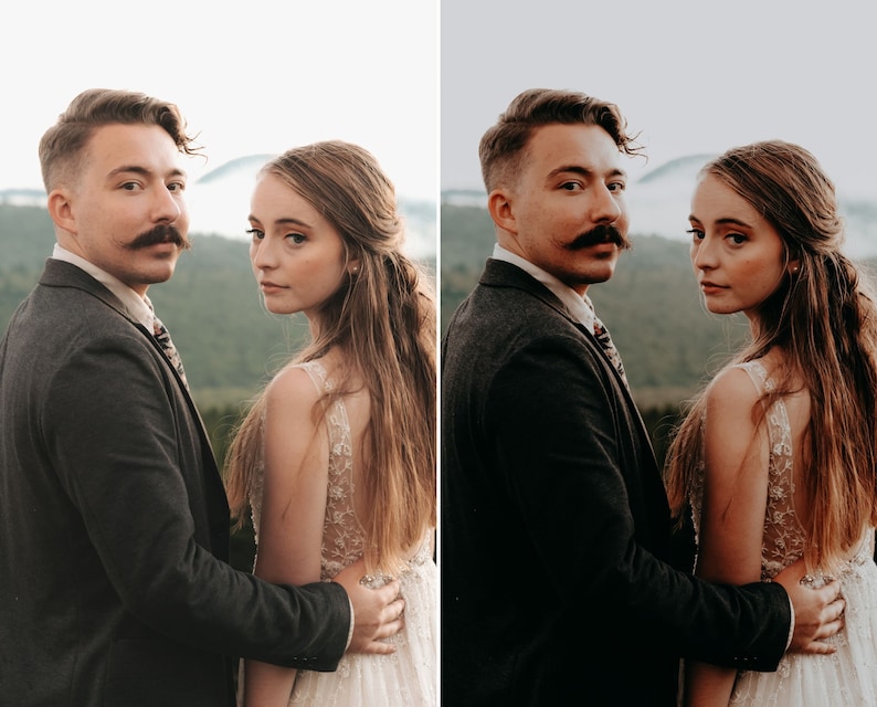 May include: A person with a mustache wearing a dark charcoal blazer and a patterned tie standing next to a person with long brown hair wearing a white sleeveless dress with intricate floral embroidery and a sheer bodice overlay.