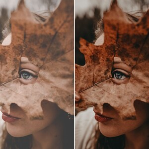 May include: A large, dried, brown maple leaf with a visible central vein and textured surface held in front of a face, partially obscuring the features while revealing one eye with a blue-grey iris and a portion of the lips with a reddish tint.