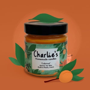 May include: A glass jar of orange-colored candle wax with a label that reads "Charlie's Homemade Candles 'L'abricot' Apricot, Soy Wax Made in Pessac, France".