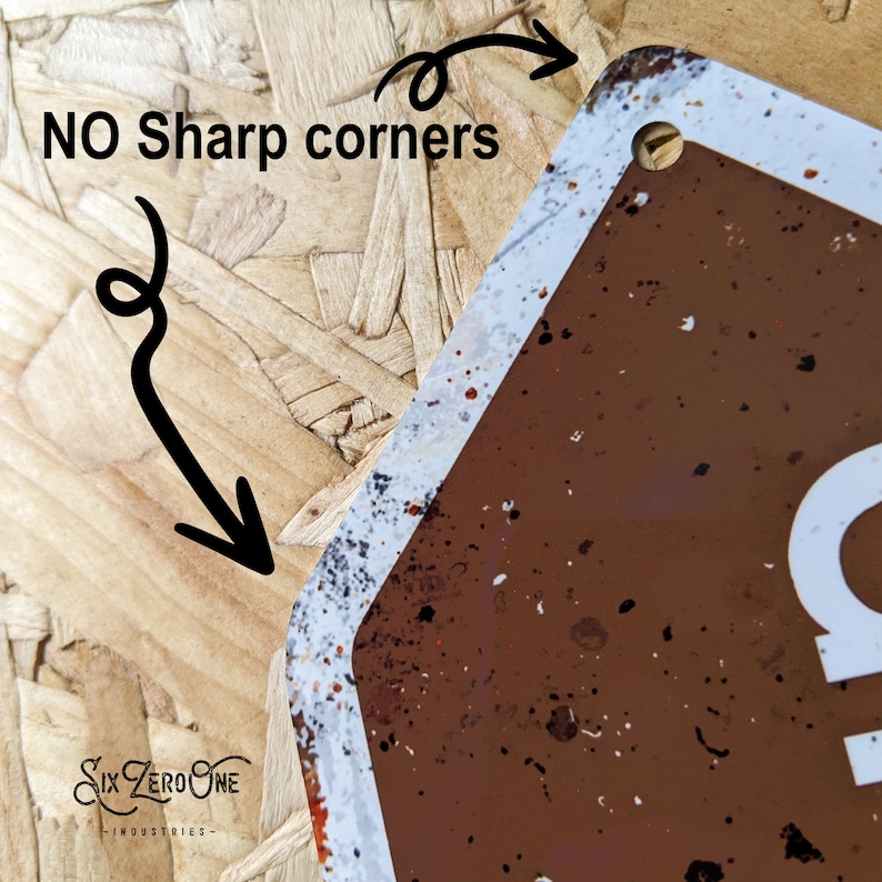 May include: Close-up of a brown metal sign with white text and a distressed finish. The sign has rounded corners and a hole for hanging. Text on the sign reads "NO Sharp corners". The logo "Six Zero One Industries" is visible.