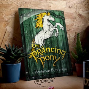 May include: A green metal sign featuring a white horse rearing up on its hind legs. The horse has a yellow mane and tail. The sign reads "The Prancing Pony" in yellow lettering with the text "by Barliman Butterbur" below. The sign is made by Six Zero One Industries.