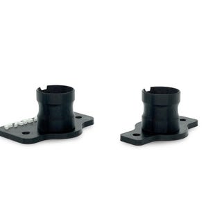 May include: Two black plastic pipe adapters with a flat base and a round opening. The adapter on the left has the word "FRACTAL" printed on the base.