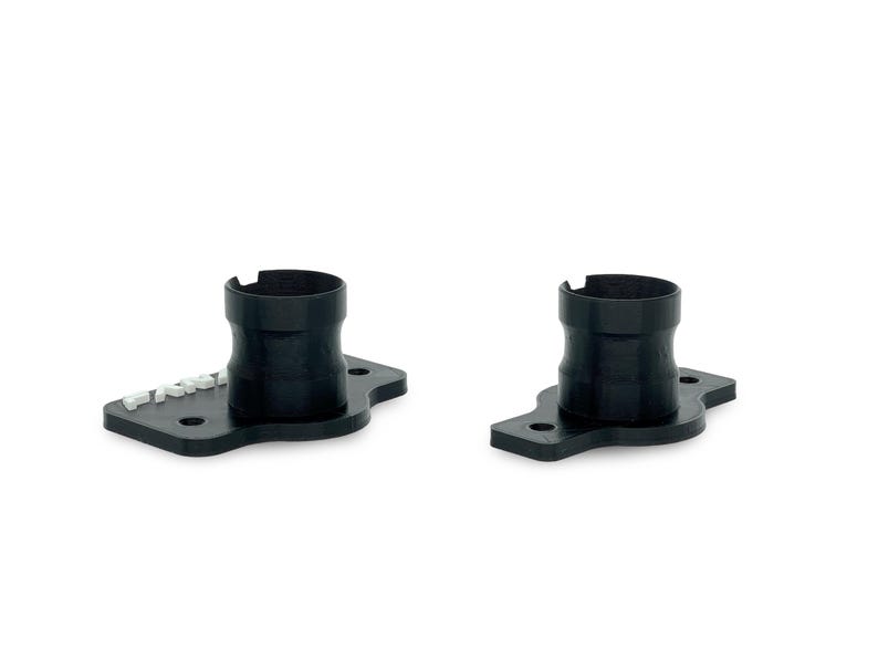 May include: Two black plastic pipe adapters with a flat base and a round opening. The adapter on the left has the word "FRACTAL" printed on the base.