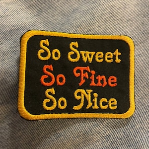 May include: A black embroidered patch with a yellow border. The patch says "So Sweet So Fine So Nice" in a stylized font.