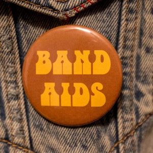 BAND AIDS  2.25 tribute Button Handmade