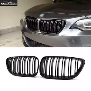 May include: A pair of black gloss car grille replacements. The grilles have a horizontal slat design.