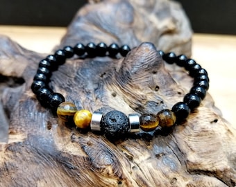 Puede incluir: Pulsera de cuentas negras con cuentas de ojo de tigre y lava.