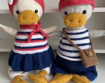 Knitted woolen toys: geese Greta (white) and Martin (grey).