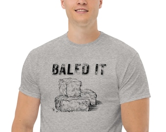 May include: A heather grey t-shirt with a black graphic of hay bales and the text "BALED IT".