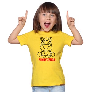 May include: A yellow t-shirt with a black and white cartoon zebra illustration and the text "FUNNY ZEBRA" in red.