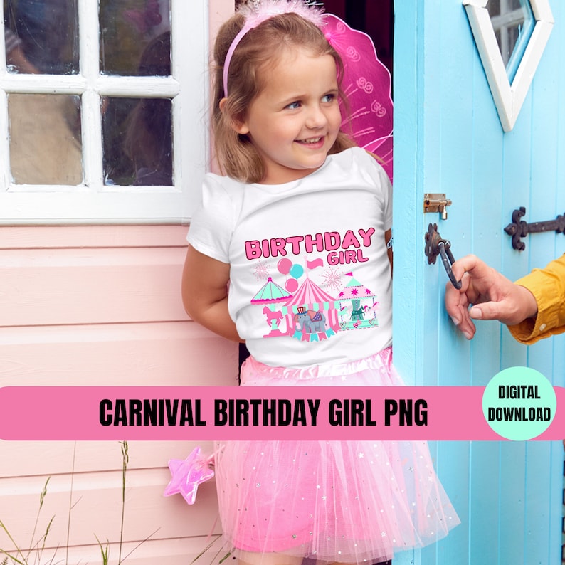 Op de afbeelding: Een wit T-shirt met een roze en blauw carnaval-verjaardagsmeisje-ontwerp. Het ontwerp bevat een tent, een draaimolen, een olifant en ballonnen. De tekst op het shirt zegt "Birthday Girl".