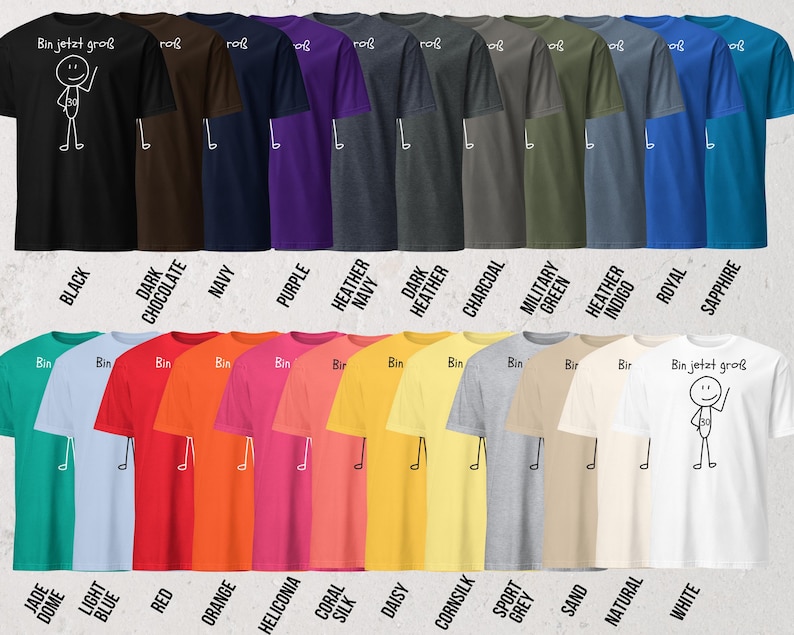 May include: A collection of short-sleeved t-shirts in various colors, including black, navy, and white. Each shirt features a stick figure design with the German text "Bin jetzt gro&szlig;". The shirts are arranged in rows, showcasing a wide range of available colors.