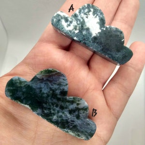 May include: Two green, white, and gray agate cloud-shaped stones. The stone labeled "A" is a lighter shade of green and white. The stone labeled "B" is a darker shade of green and white.