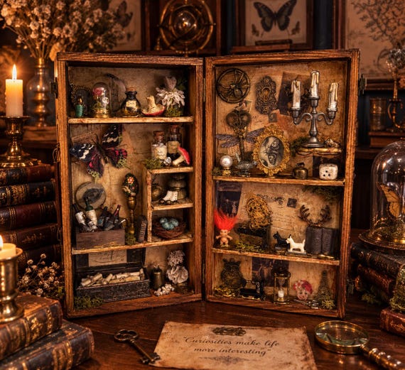 A handcrafted miniature gothic curiosity cabinet diorama — think Victorian oddities collector meets shadow box art, the kind of thing you display and people immediately ask about.