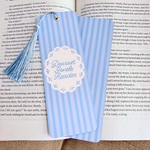 May include: Light blue and white striped bookmark with a tassel. The bookmark features the text "Dearest Gentle Reader" in a decorative font, perfect for book lovers.