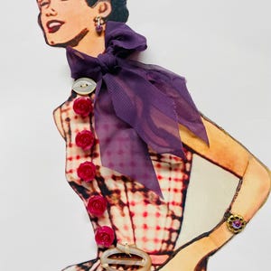 May include: A vintage illustration of a woman wearing a pink and white gingham dress with a purple bow and a row of pink rose buttons down the front. She is wearing a pair of small purple earrings.
