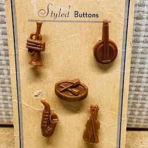 Vintage 1940s  button card with an original set of brown plastic realistic musical instrument buttons.