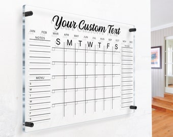 May include: A clear acrylic dry erase calendar with a grid for each month of the year. The calendar has a space for notes, a menu, and a to-do list. The text "Your Custom Text" is at the top of the calendar.