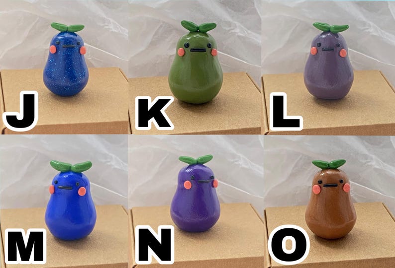 May include: Ten hand-painted ceramic figurines shaped like pears with different colors and facial expressions. The figurines are arranged in two rows of five, each on a small brown square base.
