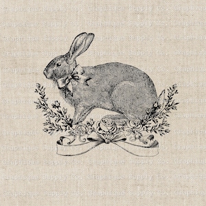 May include: A black and white illustration of a rabbit with a bow tie sitting on a bed of roses and greenery. The rabbit is surrounded by a banner with a ribbon.