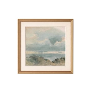 Puede incluir: Una pintura de acuarela enmarcada de un paisaje marino. La obra de arte presenta un cielo nublado con tonos de azul y blanco, y una masa de agua con una costa rocosa. El marco es de color dorado.
