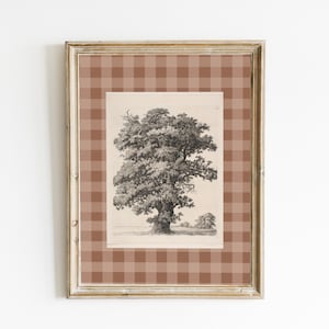 May include: Framed artwork featuring a detailed black and white tree illustration. The artwork is set against a brown plaid background within a gold-toned frame. The image is a classic, nature-themed piece.