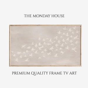 May include: A framed artwork featuring a flock of white birds in flight against a neutral background. The artwork is in a light-colored wooden frame. Text at the top reads "THE MONDAY HOUSE" and at the bottom "PREMIUM QUALITY FRAME TV ART".