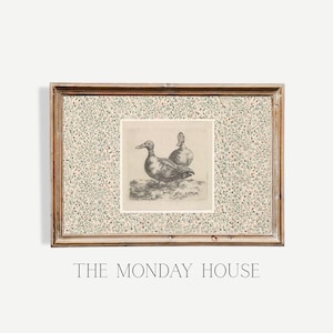 May include: Framed vintage print featuring two ducks in a detailed monochrome illustration. The artwork is set against a floral patterned background and framed in a rustic wooden frame. The text "THE MONDAY HOUSE" is displayed at the bottom.