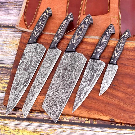 A full Damascus steel knife set with the swirling pattern that makes every chef stop and stare — functional heirloom-grade kitchen art.