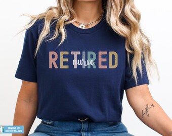 May include: A navy blue t-shirt with the text "RETIRED nurse" in colorful, distressed lettering.
