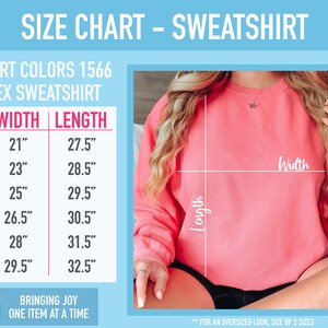 May include: Size chart for a unisex sweatshirt in Comfort Colors 1566. The chart shows the width and length measurements in inches for sizes S, M, L, XL, 2XL, and 3XL. The text "For an oversized look, size up 2 sizes" is at the bottom of the chart.
