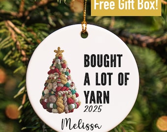 May include: White ceramic Christmas ornament with a yarn-themed Christmas tree design. Text reads "BOUGHT A LOT OF YARN 2025" and "Melissa". Includes a gold string for hanging. The words "Free Gift Box!" are in a gold box.
