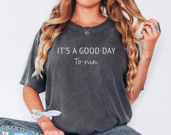 May include: A dark grey t-shirt with the text "It's a good day to run" in white lettering.