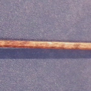 May include: A wooden walking stick with a silver butterfly design at the top.