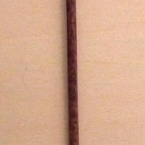 May include: A brown wooden walking stick with a silver and gold decorative top.
