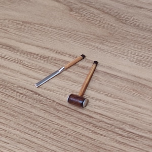 May include: Two wooden tools, one with a metal blade and the other with a wooden mallet head.