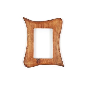 May include: A wooden picture frame with a distinctive, curved design. The frame is made of light brown wood with visible grain and a rectangular aperture. The frame's edges curve outwards, creating an elegant, organic shape.