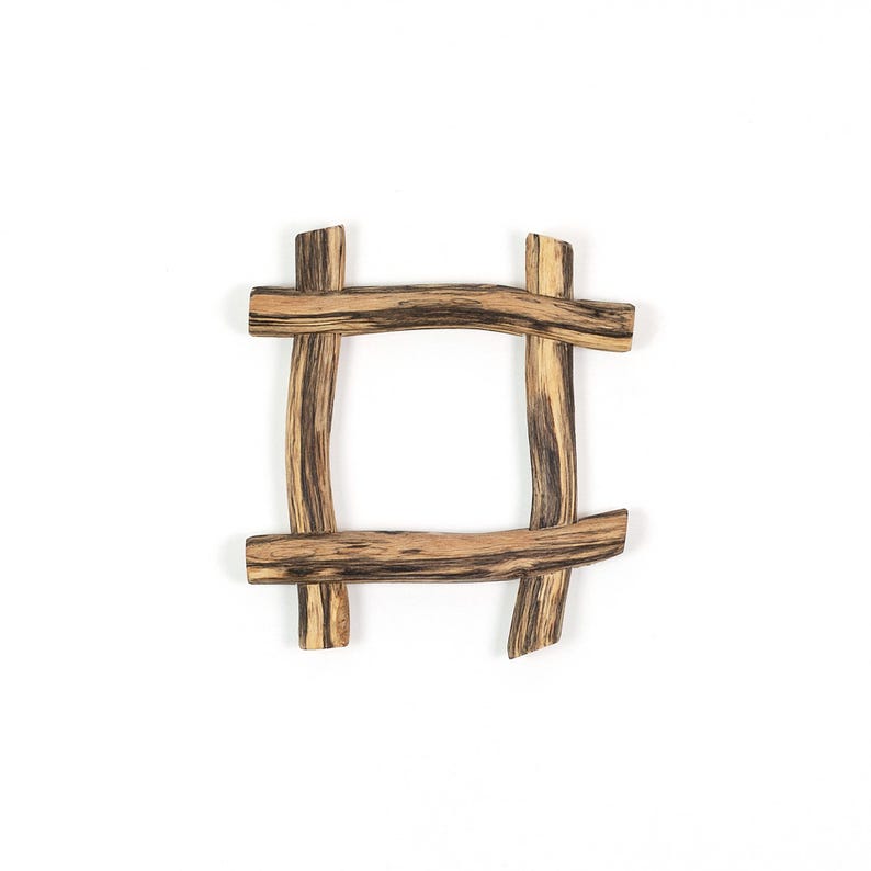 May include: A square frame constructed from four pieces of natural wood arranged in a hashtag pattern. The wood features a light tan base color with prominent dark brown grain lines and streaks running horizontally and vertically throughout.