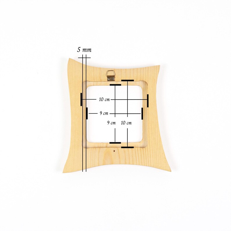 May include: A light-coloured wooden picture frame with a curved, hourglass-like silhouette. The frame features a central square opening measuring 9 cm by 9 cm, with outer dimensions of 10 cm by 10 cm and a thickness of 5 mm, including a metal hanger.